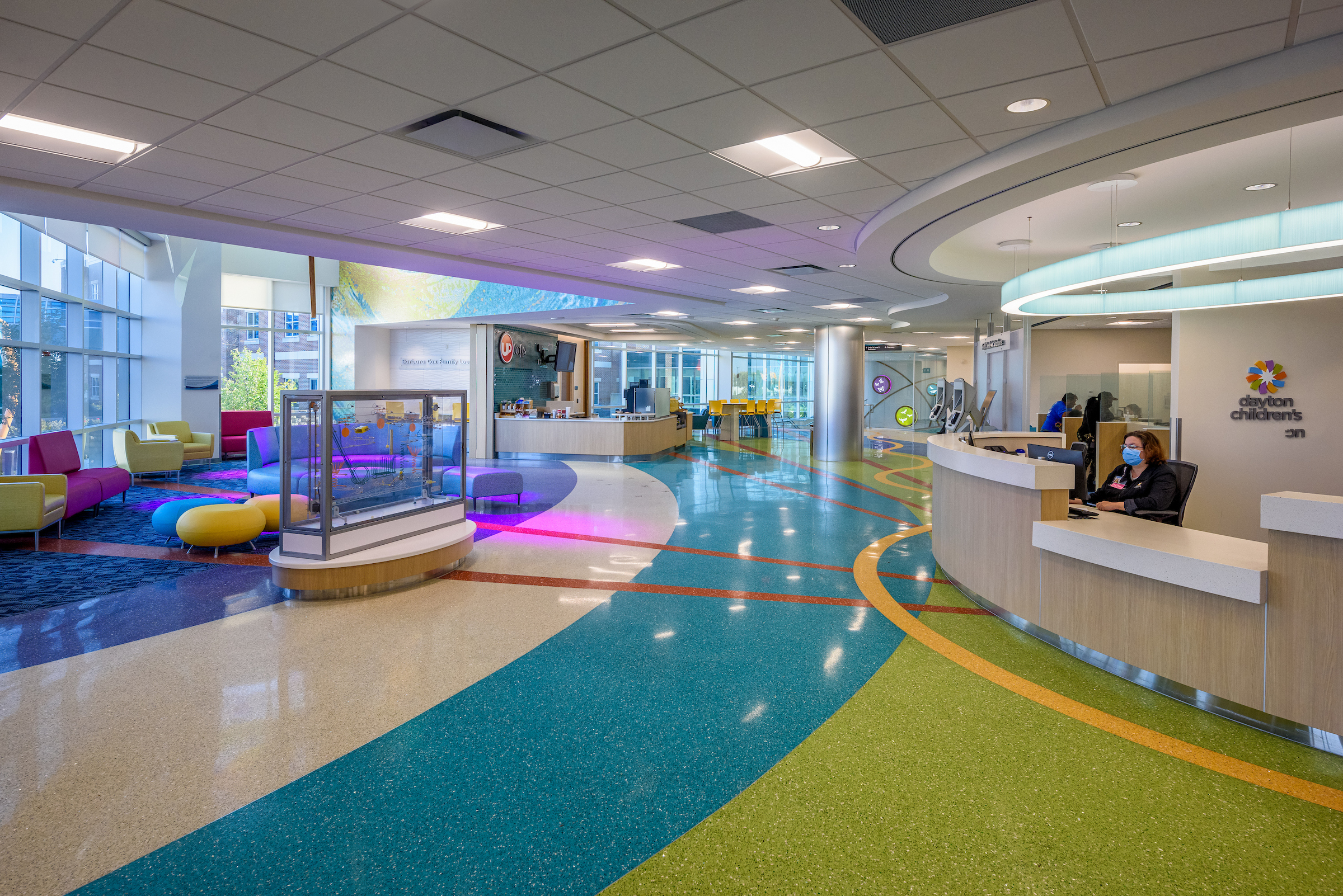 Bright entrance at specialty care center with welcoming front desk and kid-friendly waiting area.