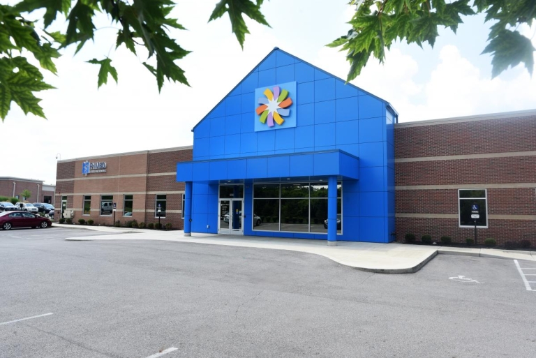 exterior view urgent care with blue wall at entrance