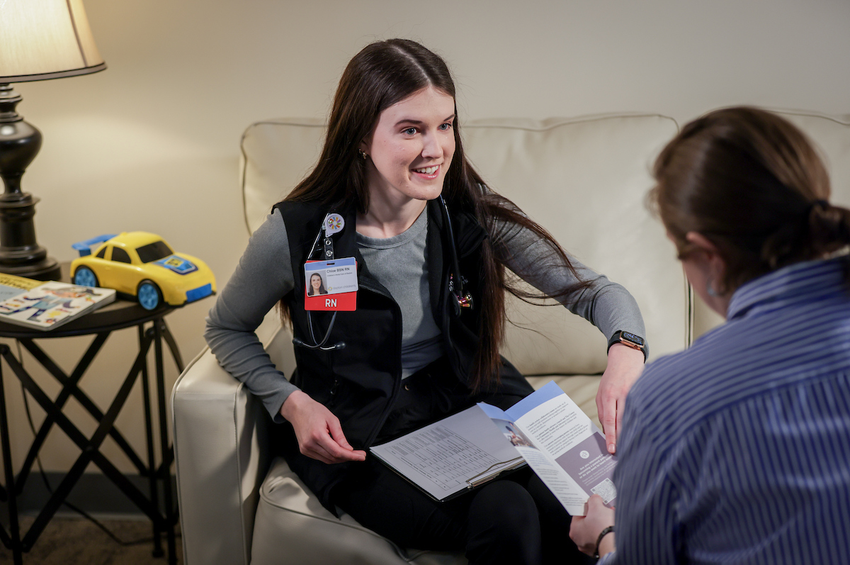 nurse discussing child's care plan with mom during a home care visit