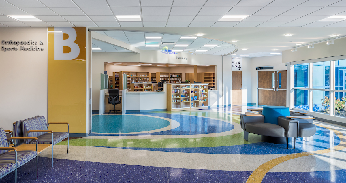 Bright, colorful lobby with a pharmacy and the entrance to orthopedics and sports medicine