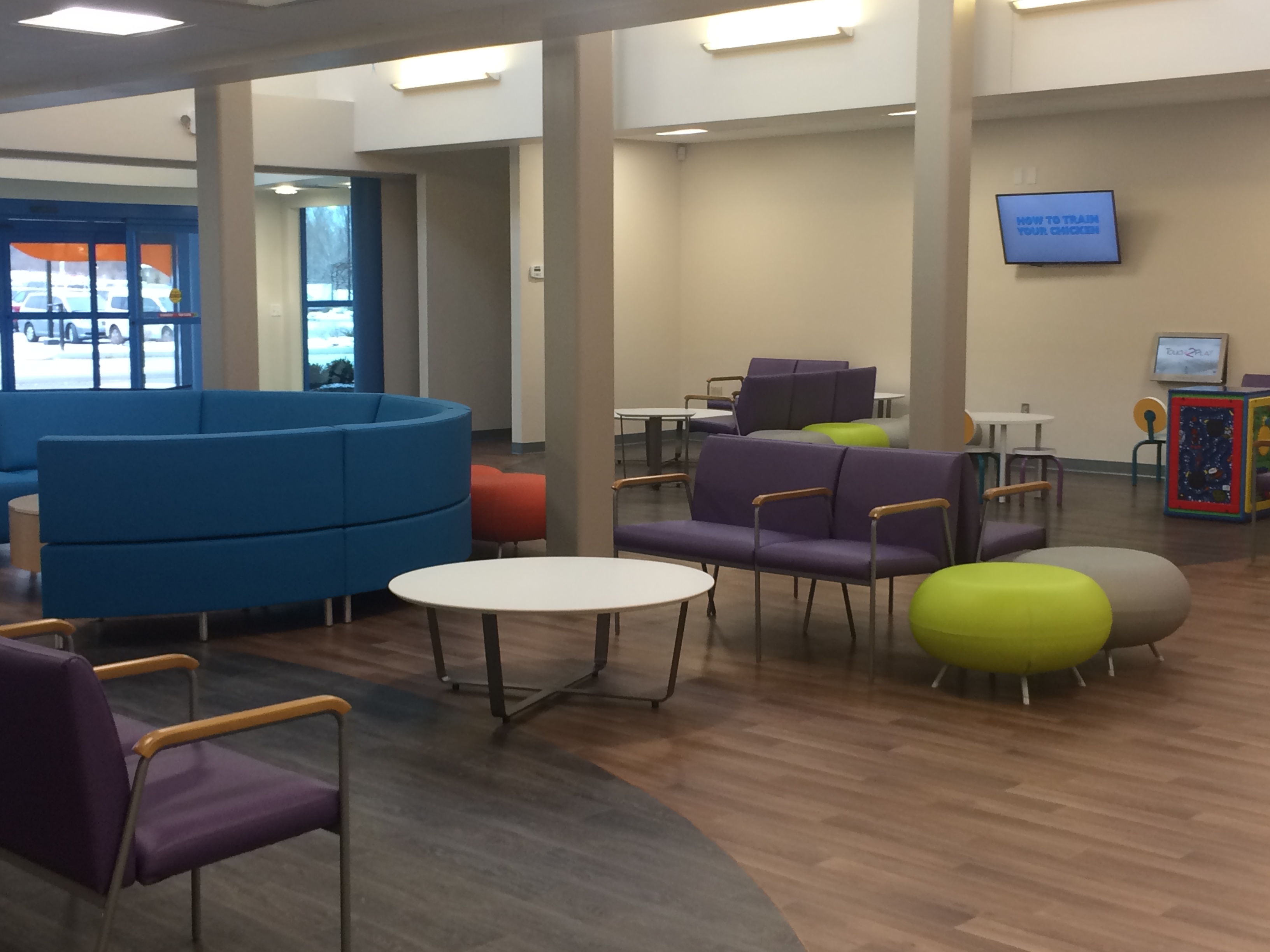 Bright waiting room with colorful furniture in care center.