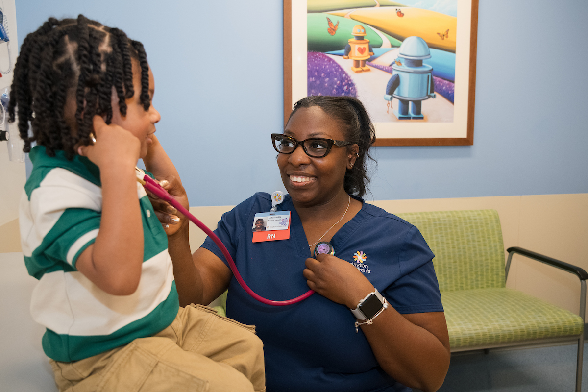 nurse practitioner giving exam to patient