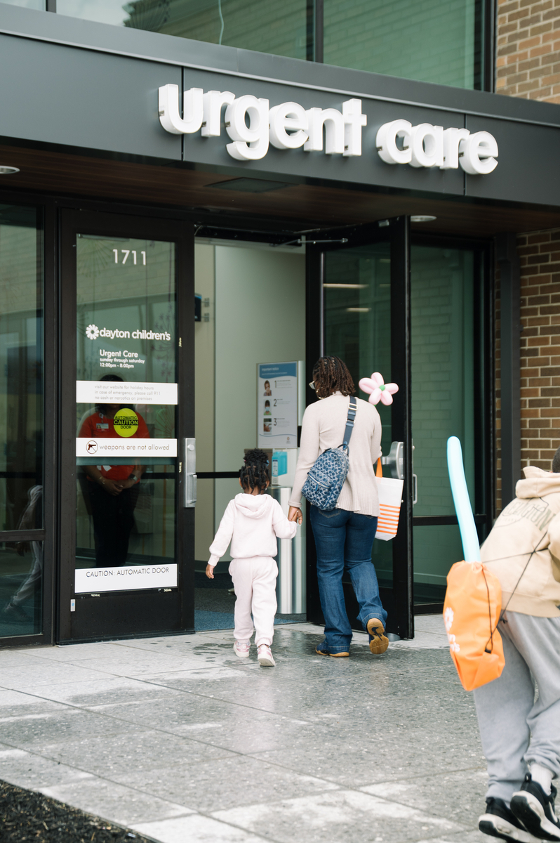 parent and child entering urgent care location for a minor injury or illness