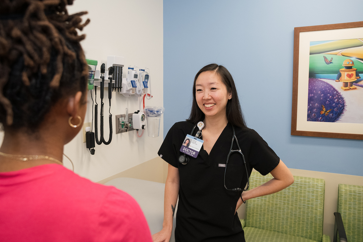 doctor talking with mom after child's urgent care exam